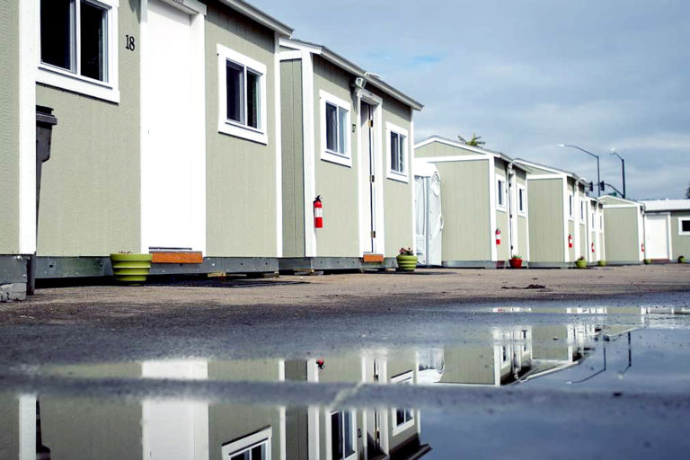 Protect CA - News - California’s default mental institutions - Image of Tuff Shed shelters line the Lake Merritt Community Cabins site in Oakland, California